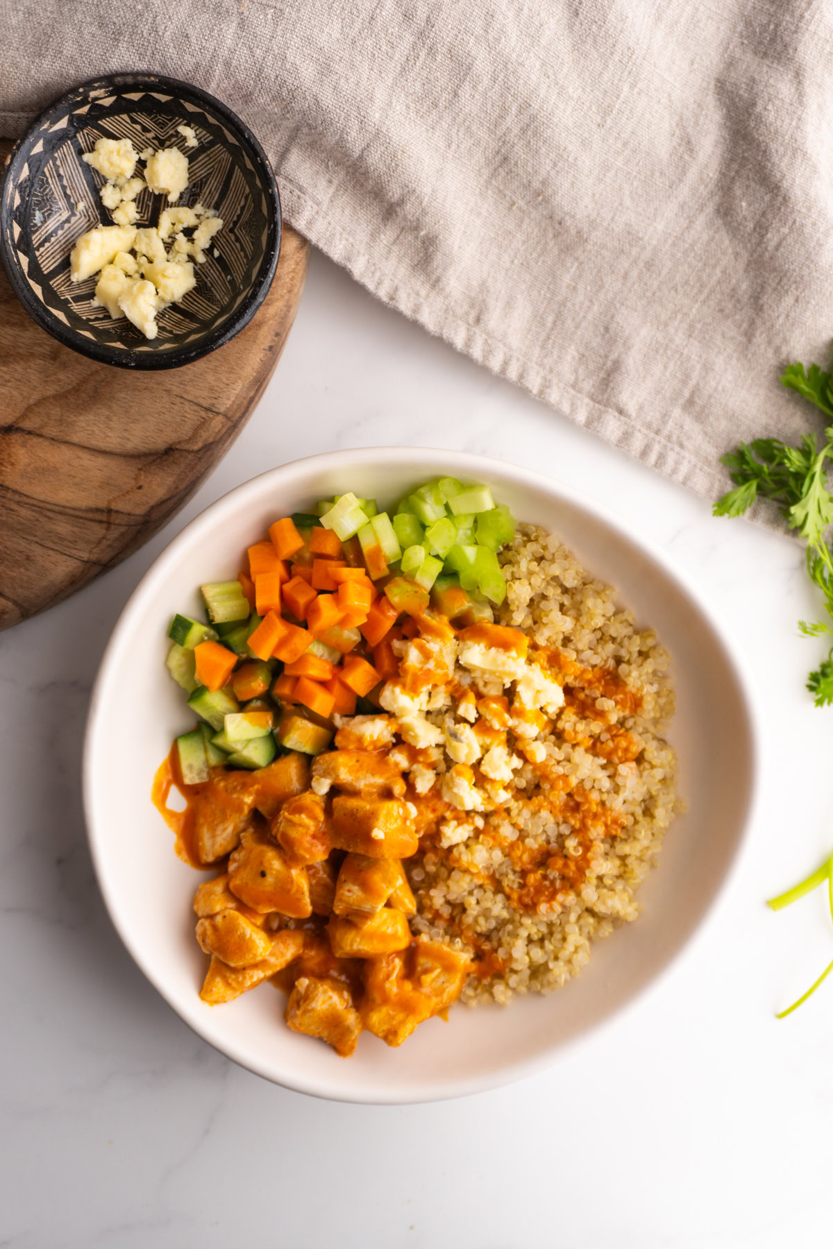 Buffalo chicken bowl with blue cheese and buffalo sauce drizzled on top.