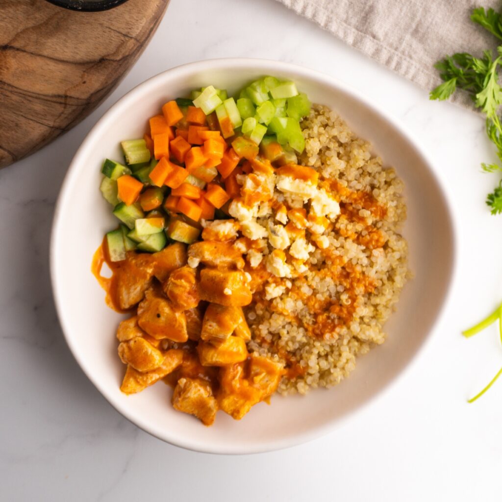 Buffalo chicken bowl served in a white bowl.