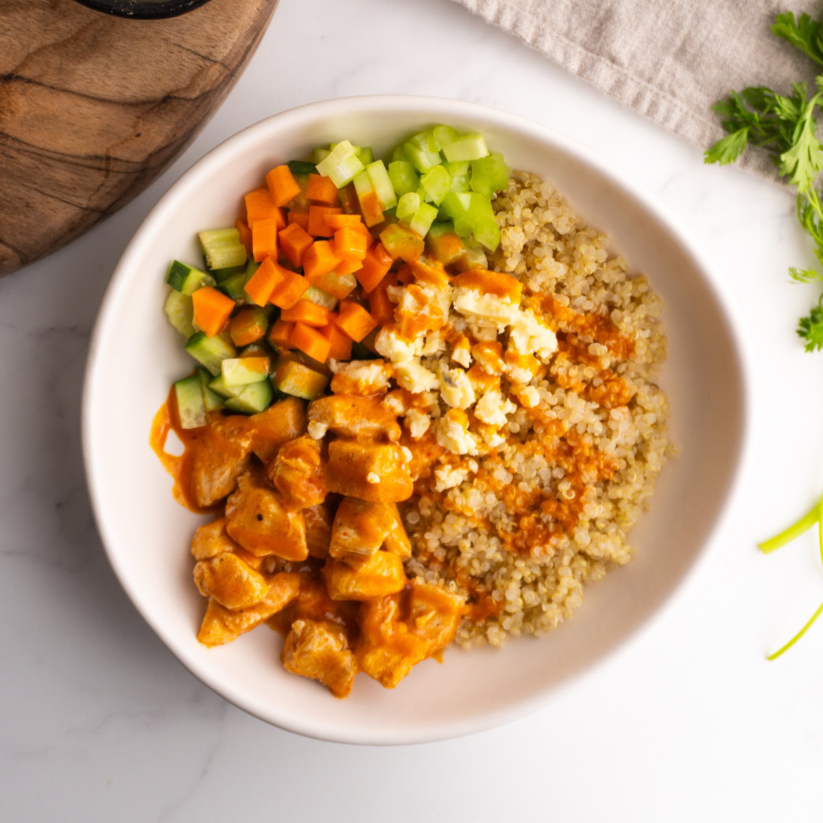 Buffalo chicken bowl served in a white bowl.