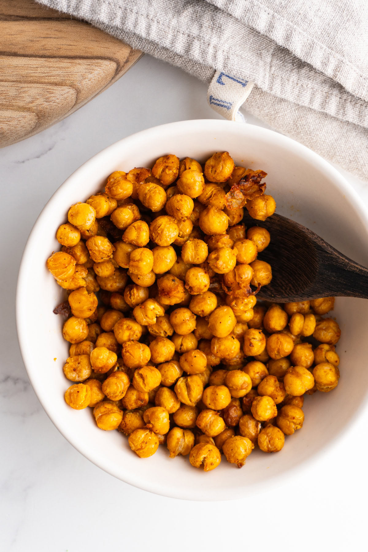 Bowl of crispy air fried chickpeas with a spoon in the bowl.