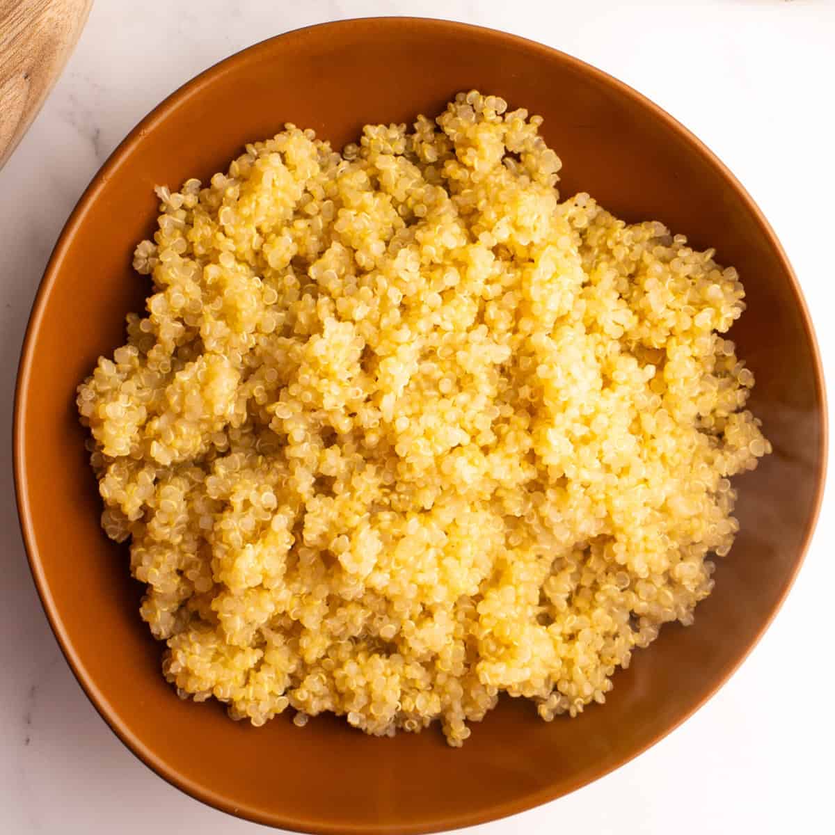 Quinoa served in a brown bowl.