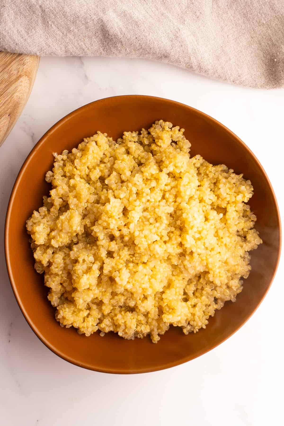 Quinoa made on the stove served in a clay bowl.