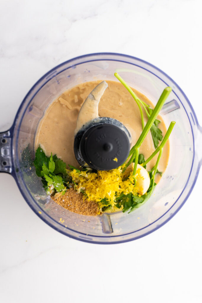 Ingredients for lemon tahini sauce in the food processor.