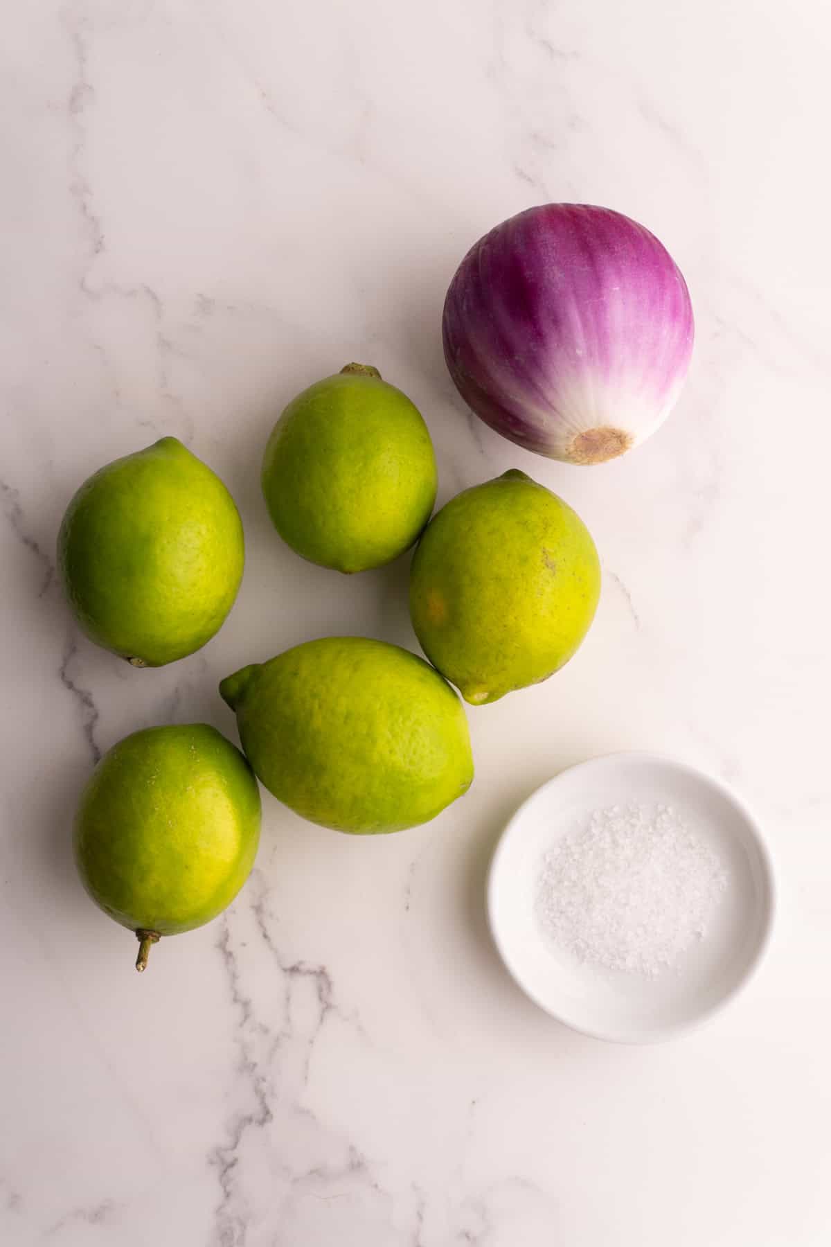 Ingredients needed to make lime pickled onions.