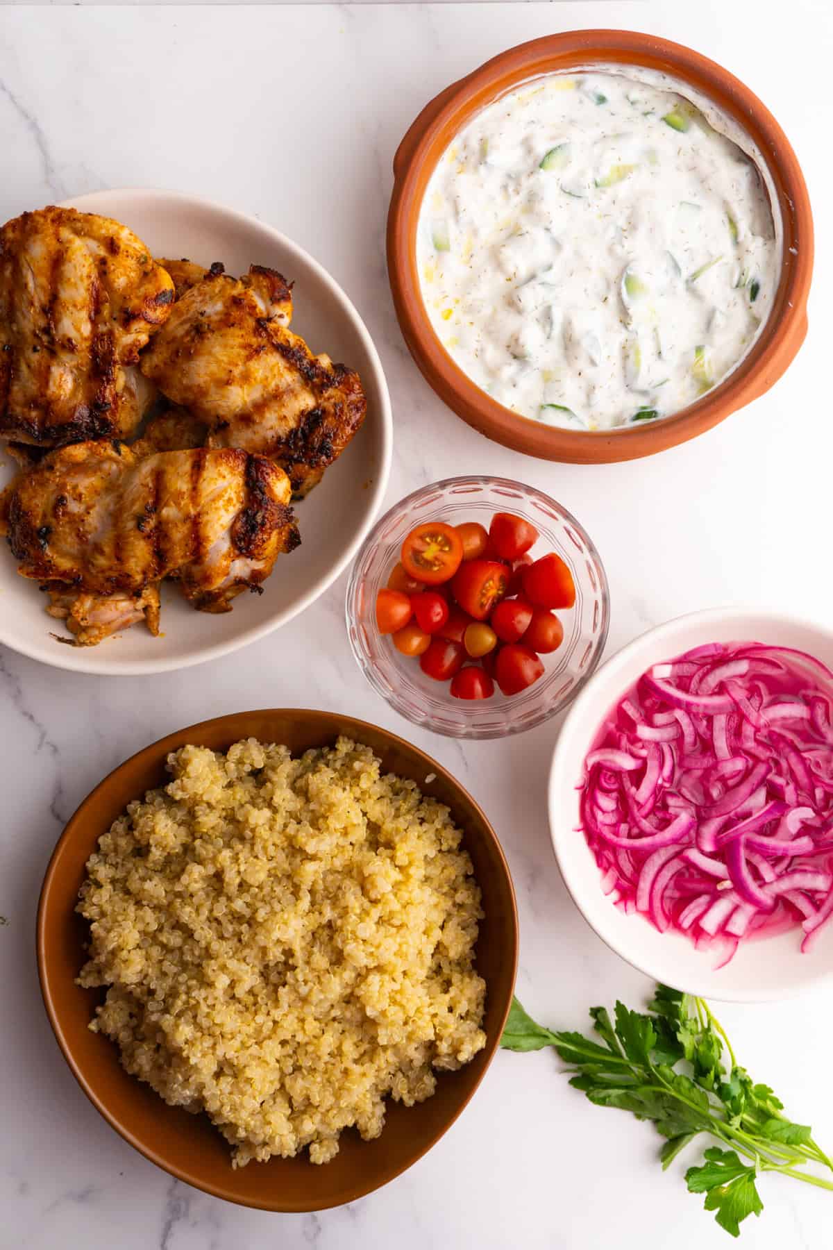 Ingredients needed to make mediterranean chicken quinoa bowls.