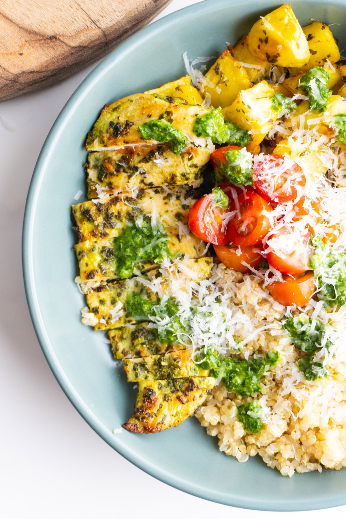Close up of the sliced pesto chicken in a grain bowl.