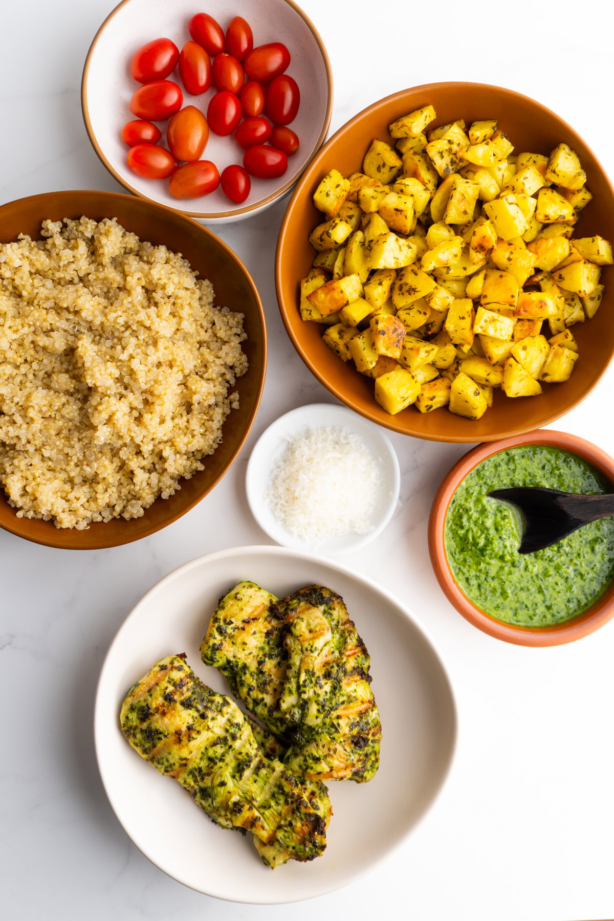 Ingredients needed to make pesto chicken bowls.