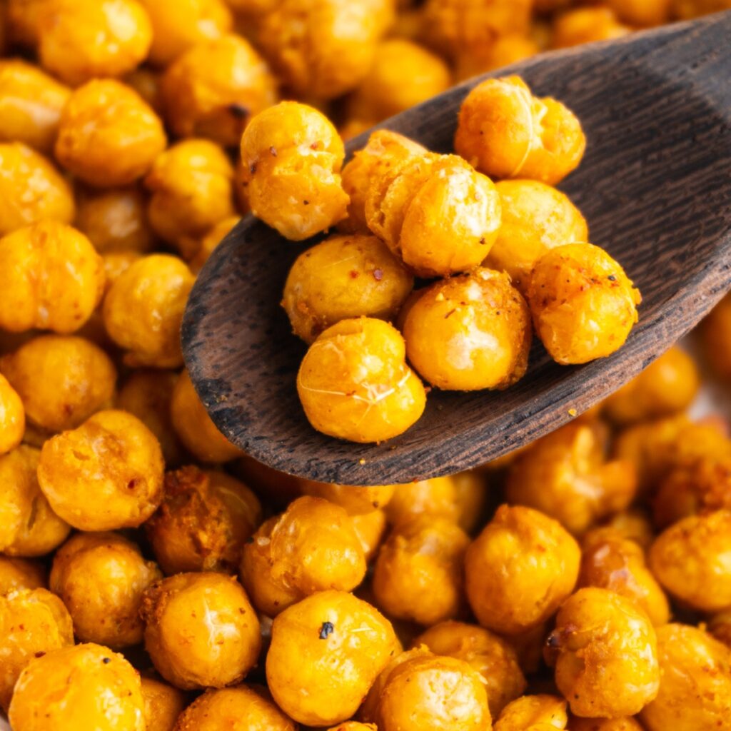 Close up of crispy air fryer chickpeas on a wooden spoon.