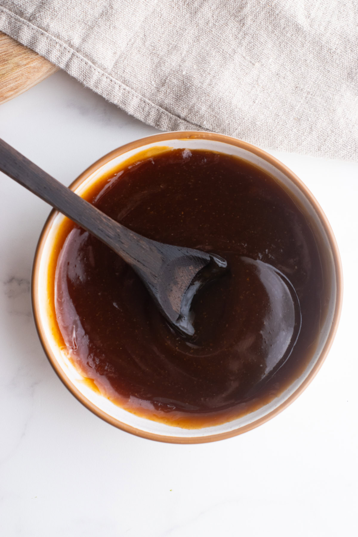 Homemade teriyaki sauce in a bowl with a spoon.