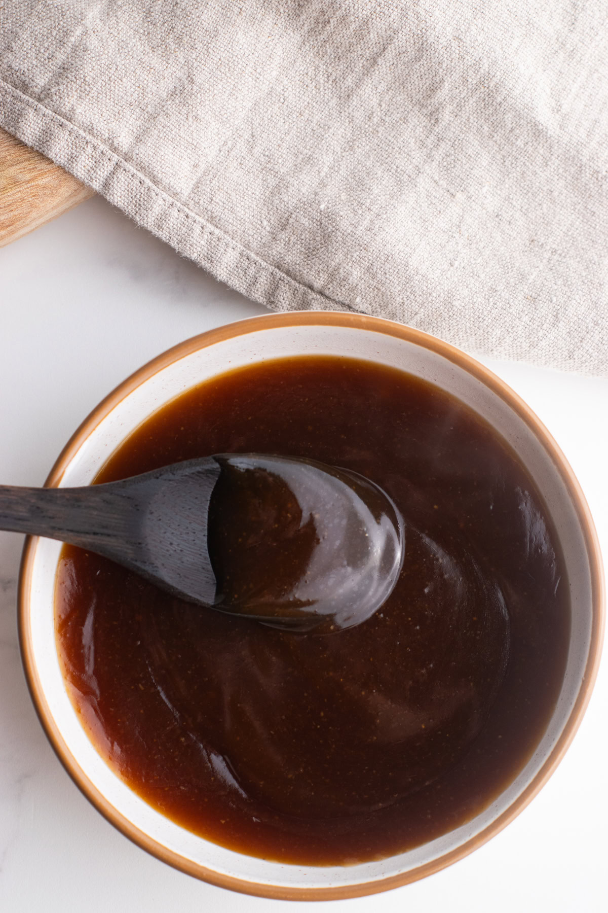 Teriyaki sauce in a small bowl with a spoon.