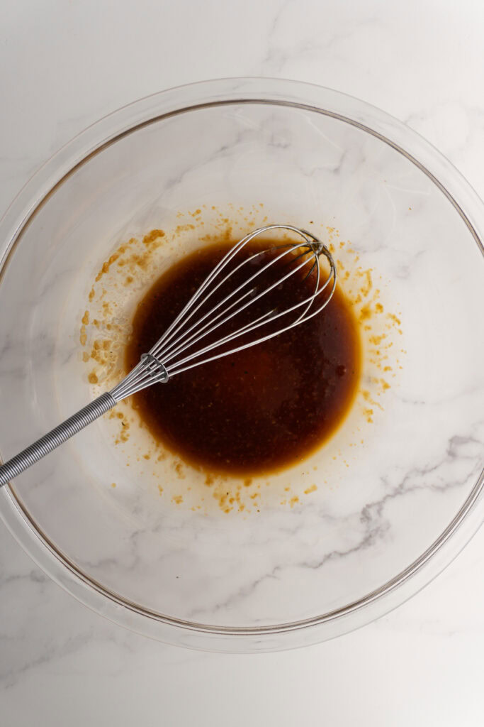 Salmon marinade in a bowl with a whisk.