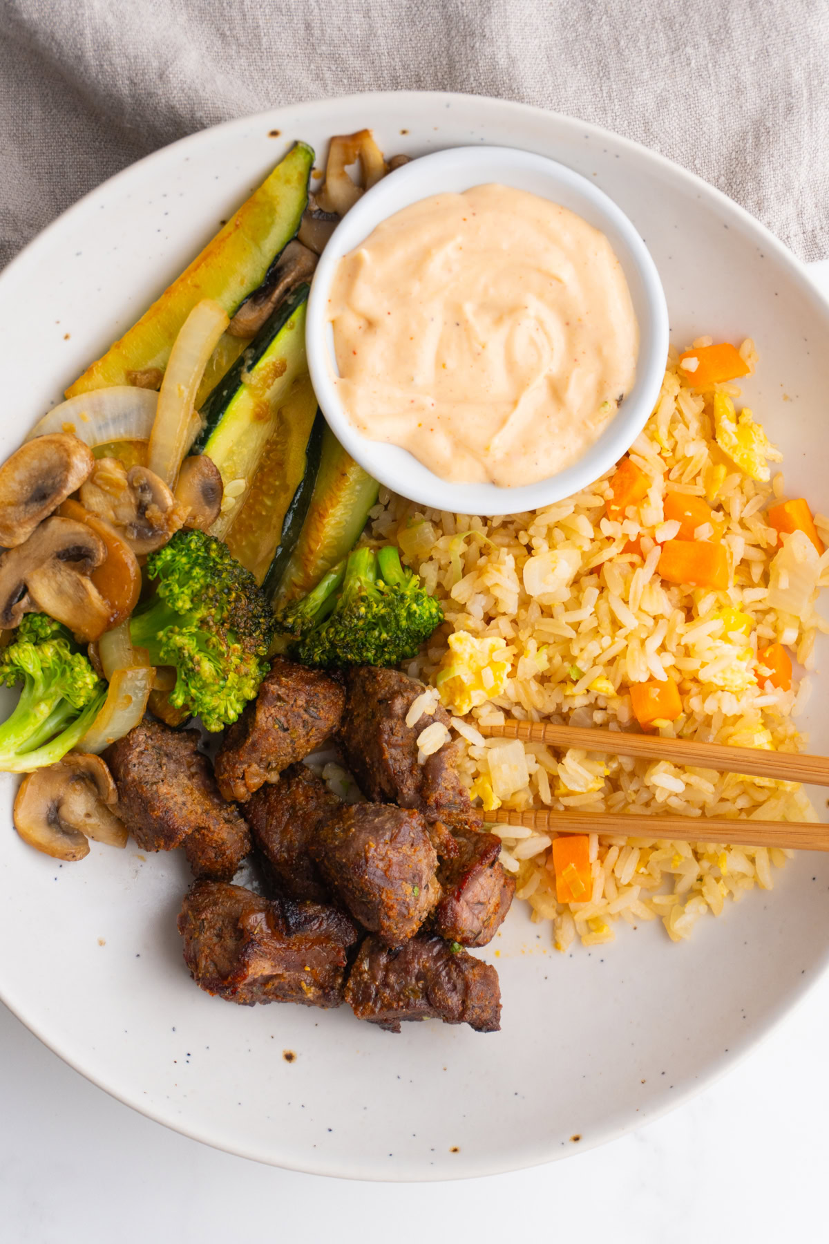 Hibachi steak bowls with rice, veggies, steak, and sauce.