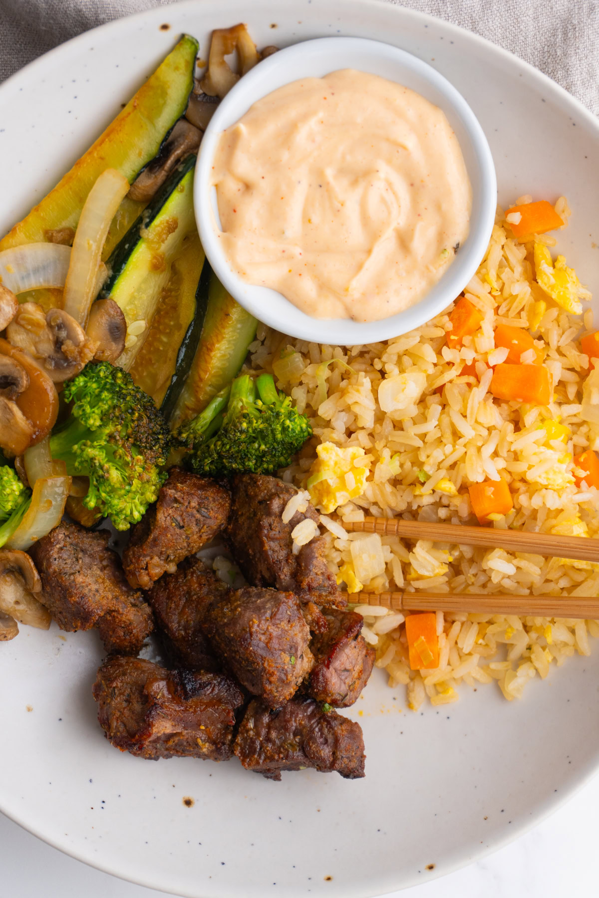 Close up of hibachi steak bowls with chopsticks on the side.