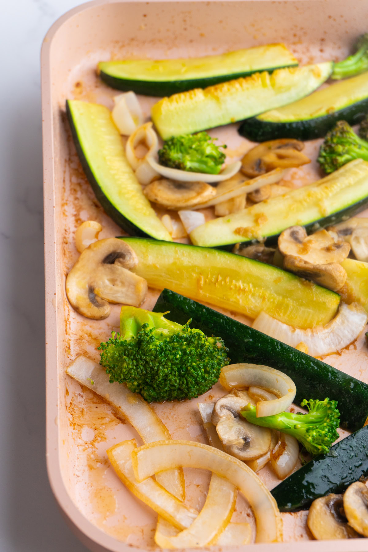 Side view of hibachi style veggies in a pan.