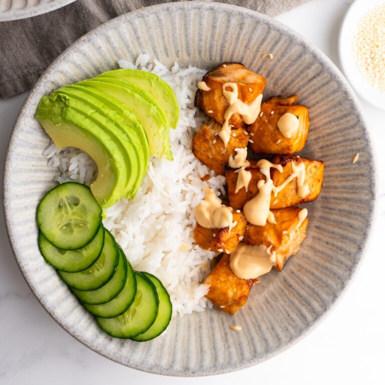 Air fryer salmon bowls with cucumber, avocado and spicy mayo on top.