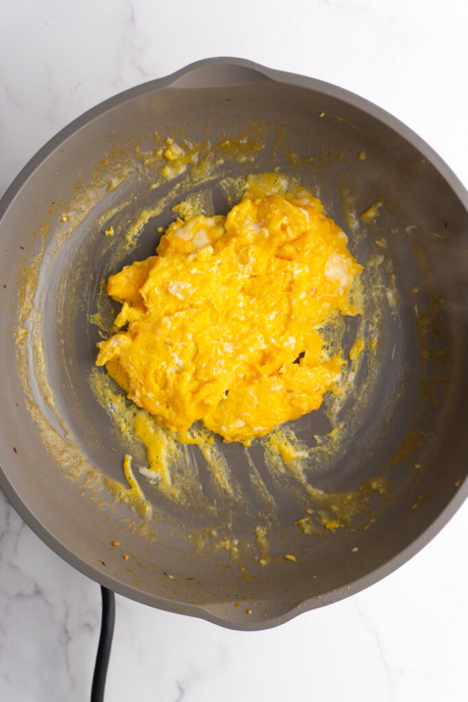 Scrambled eggs in a pan.