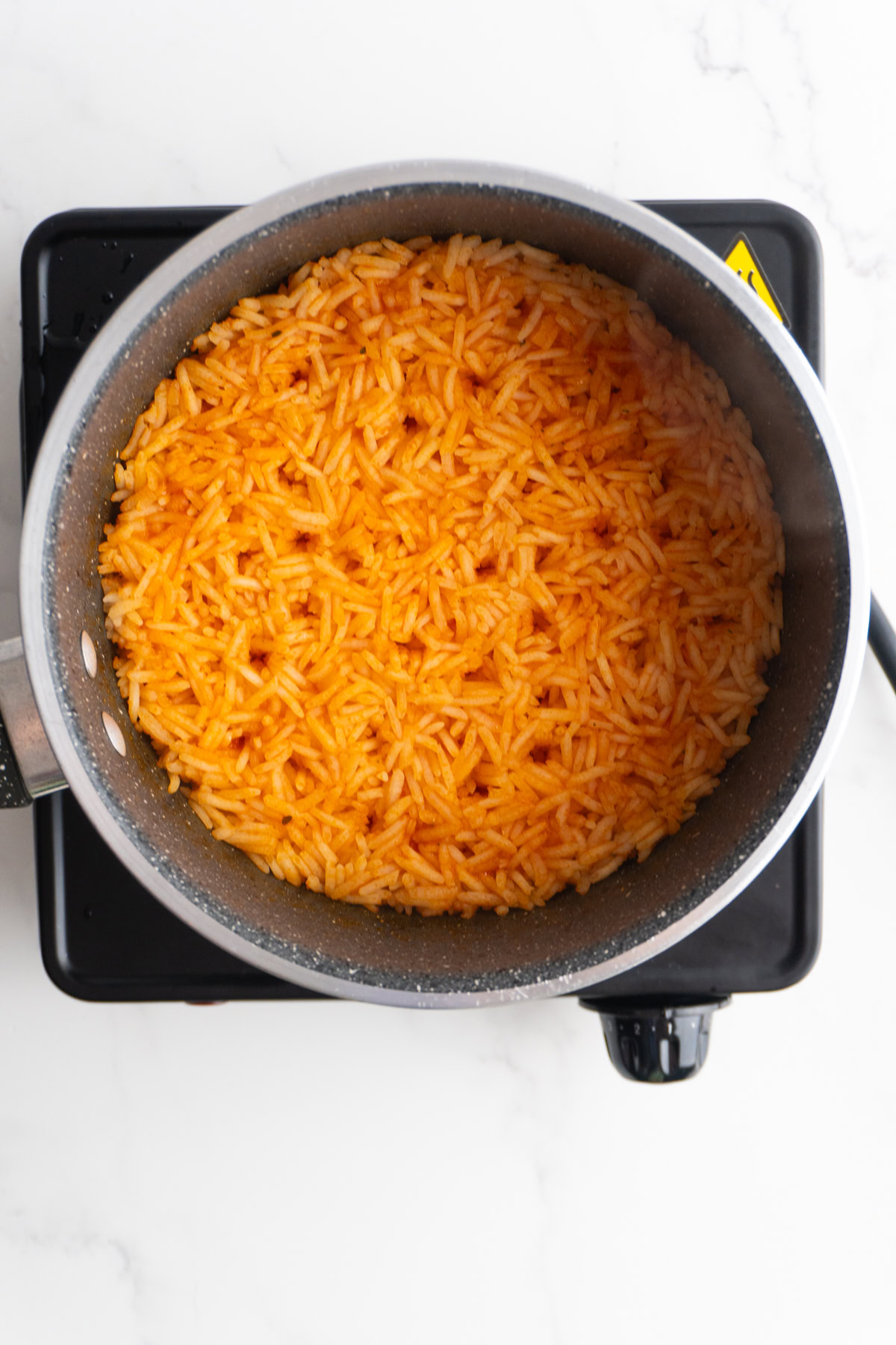Finished Mexican style rice in a saucepan before being fluffed.