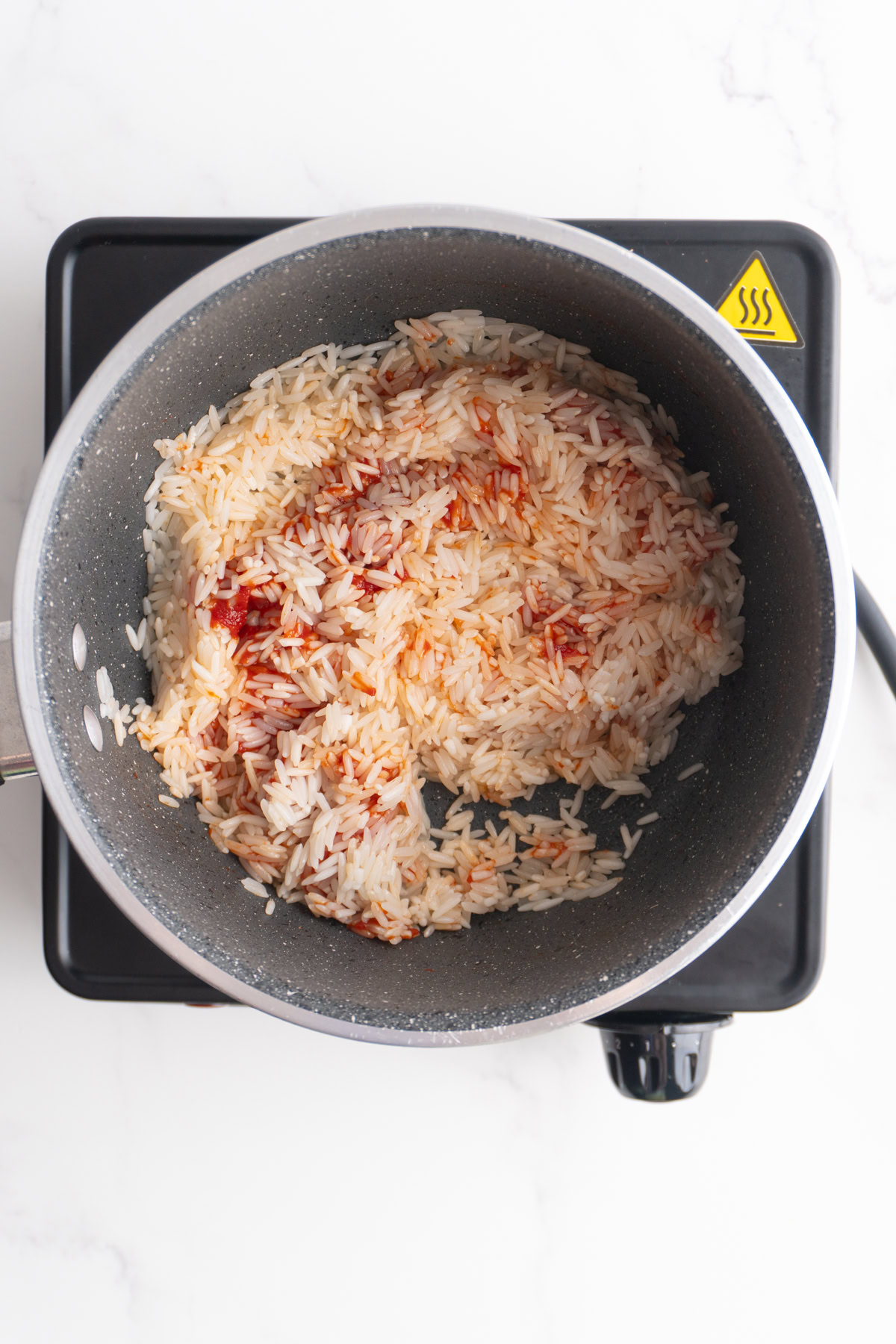 Tomato paste added to the toasted rice,