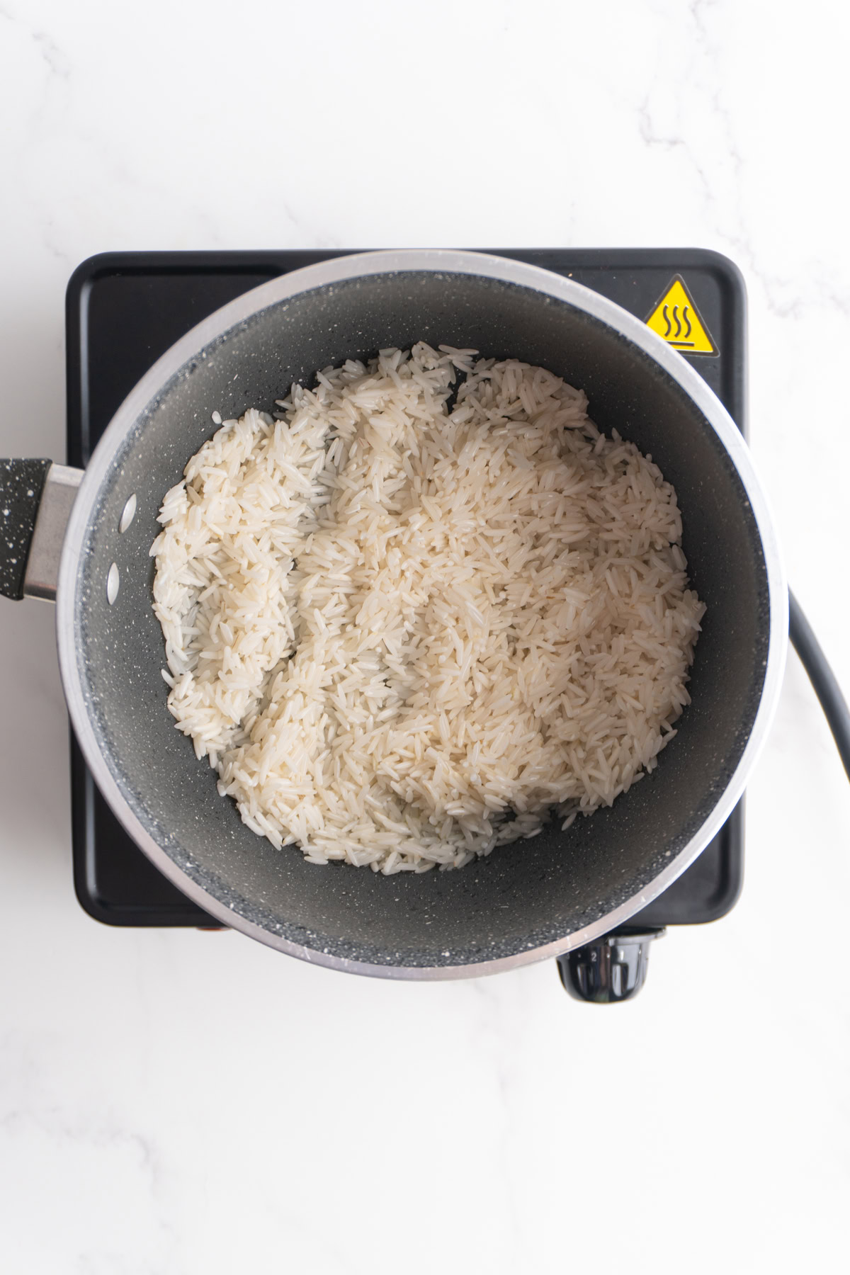 Rice toasting in a saucepan.