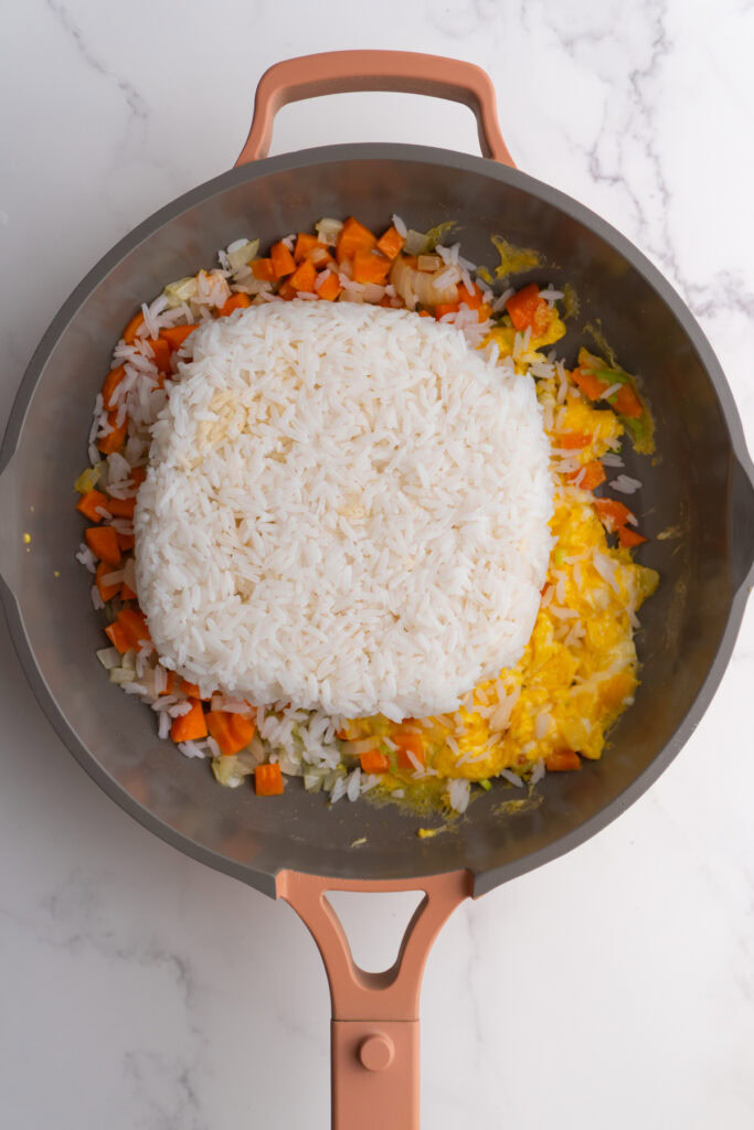 Chilled rice added to the skillet.