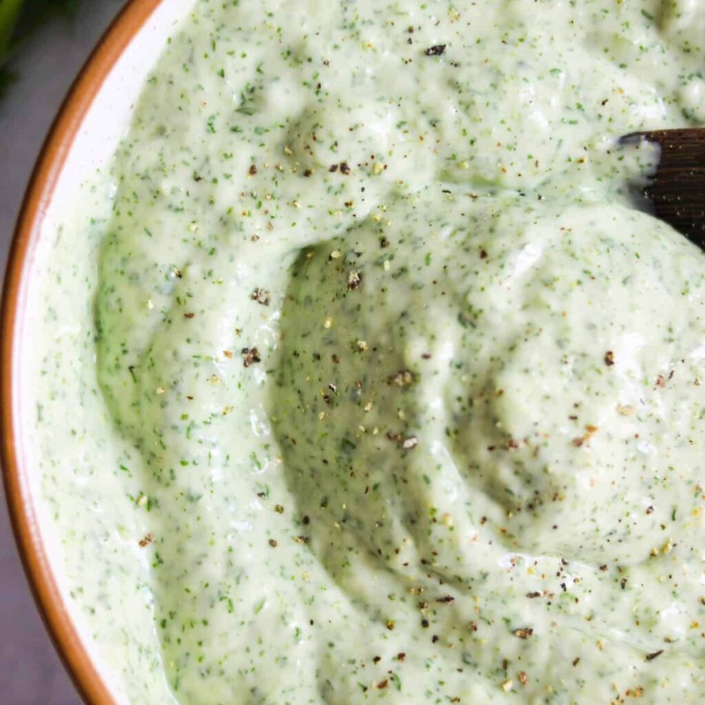 Close up of jalapeño cilantro sauce in a bowl.