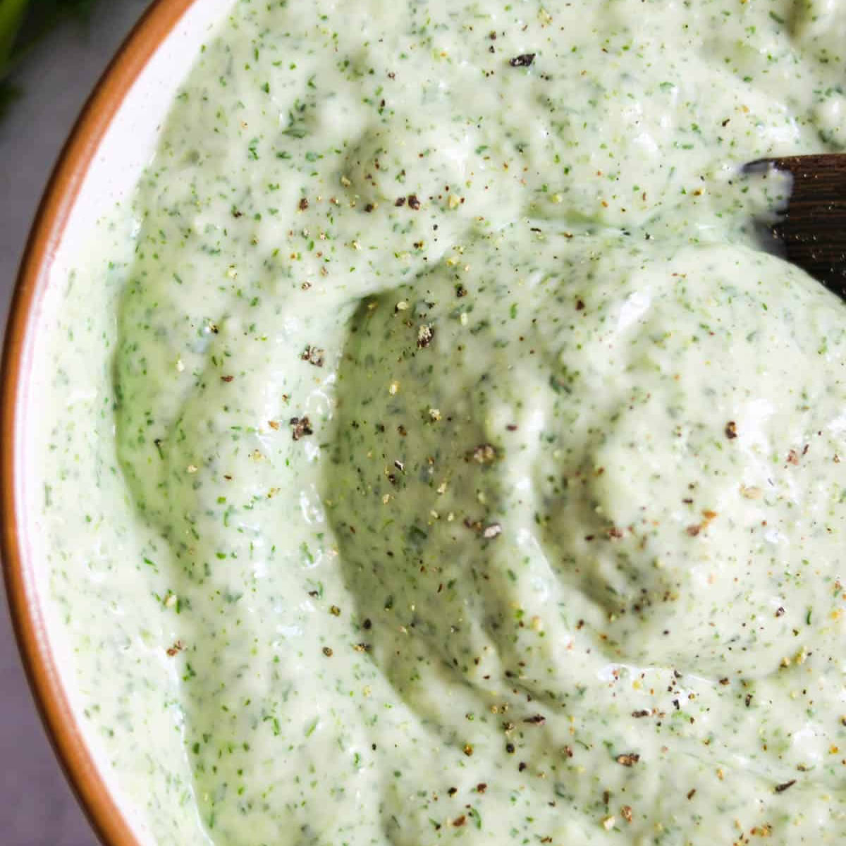 Close up of jalapeño cilantro sauce in a bowl.