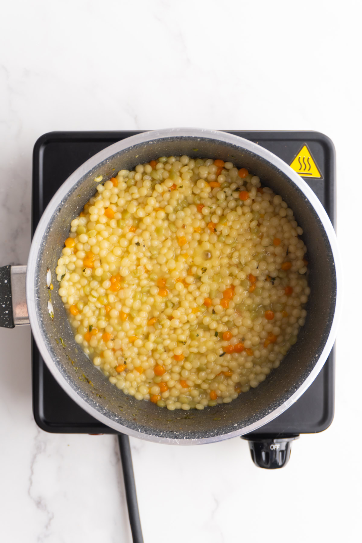 Couscous cooking in a saucepan.