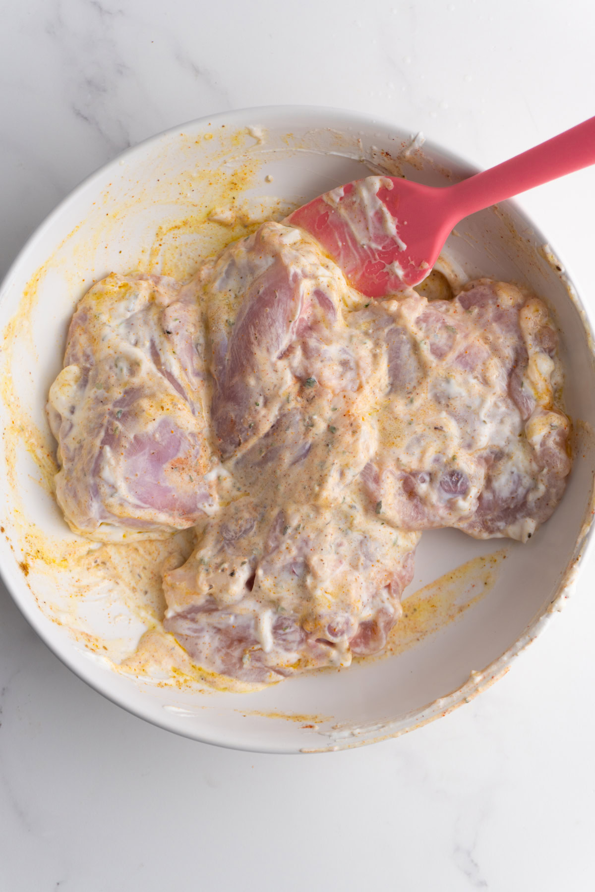 Chicken thighs in yogurt shawarma marinade.