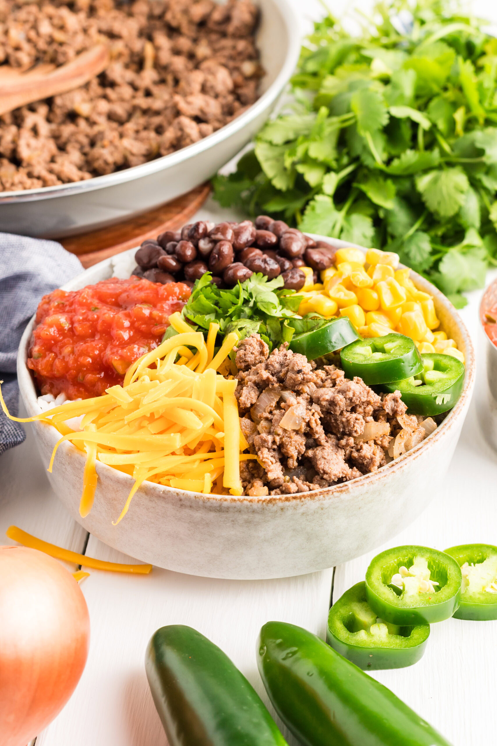 Ground beef taco bowl with toppings like salsa, black beans, corn and cheese.