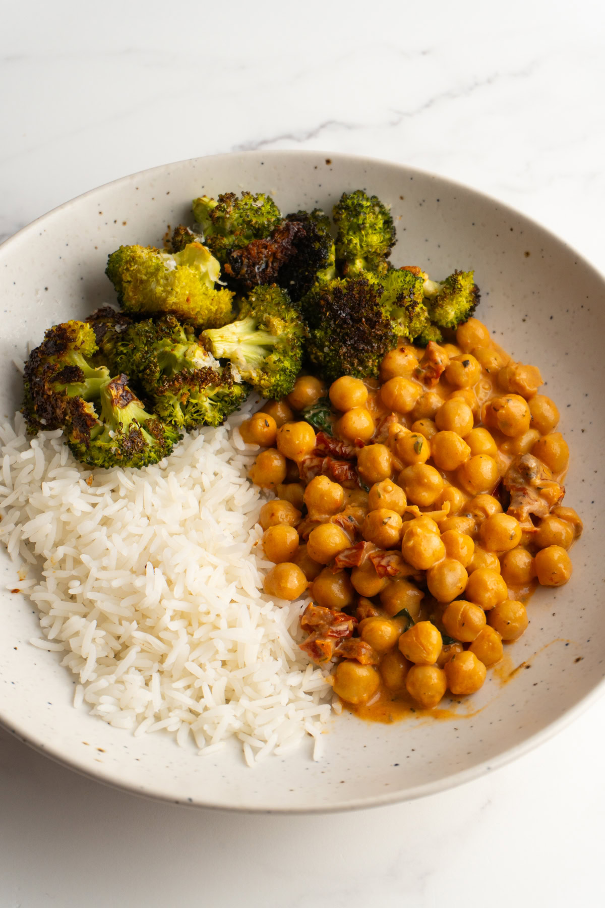 Marry me chickpeas served with rice and broccoli.