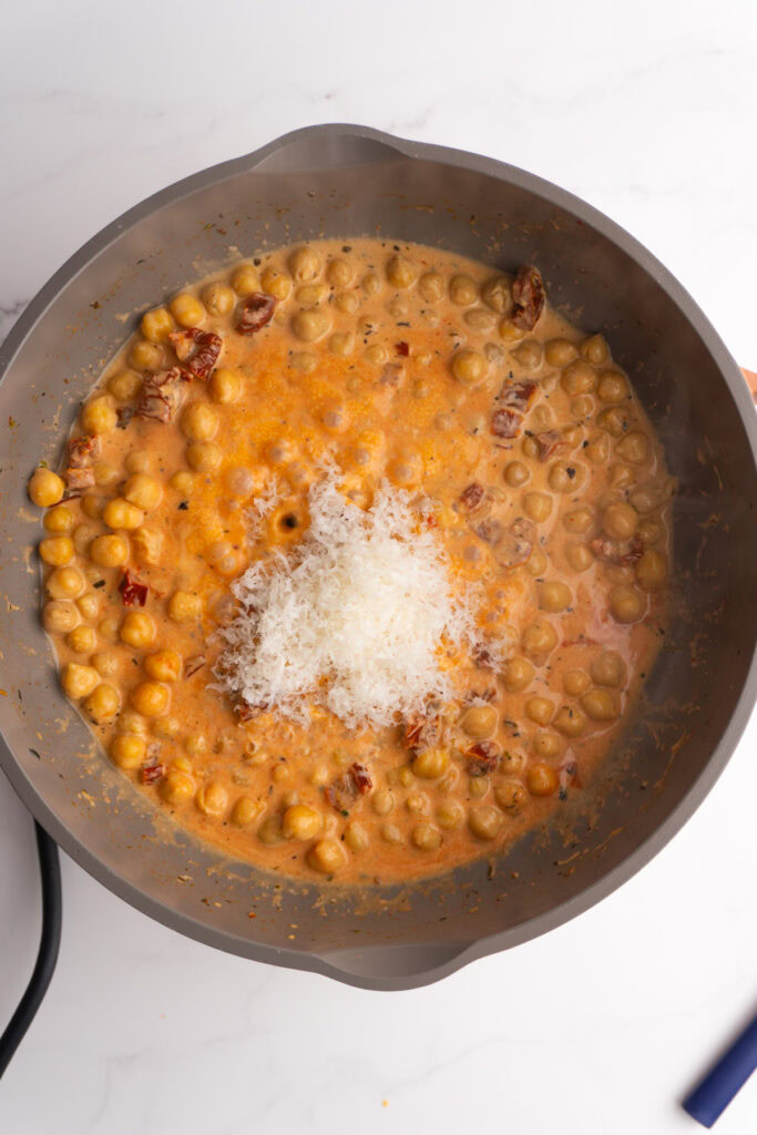 Heavy cream and parmesan added to the skillet.