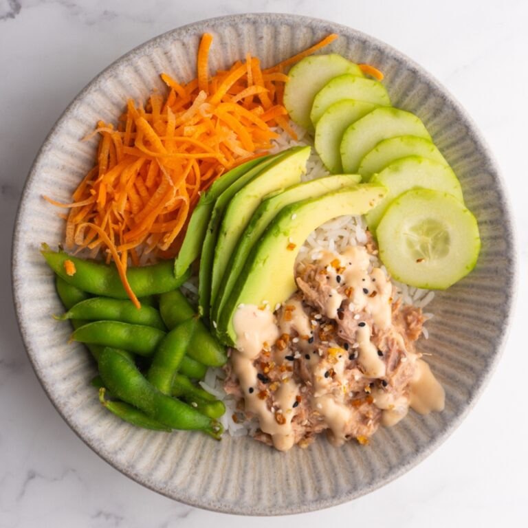 Spicy tuna bowl with rice, edamame, avocado, cucumber and carrots.