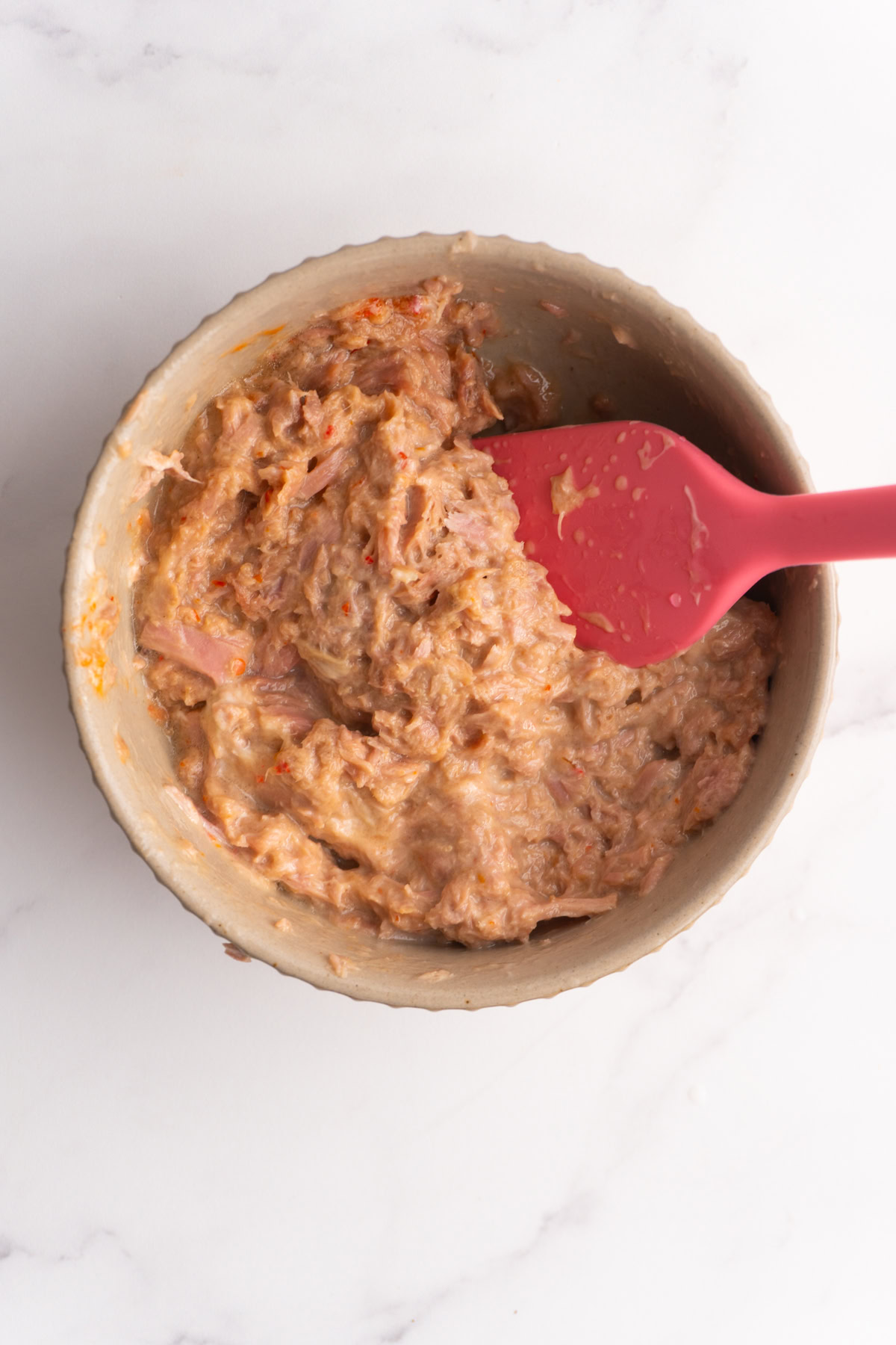 Tuna mixed with spicy mayo in a bowl.