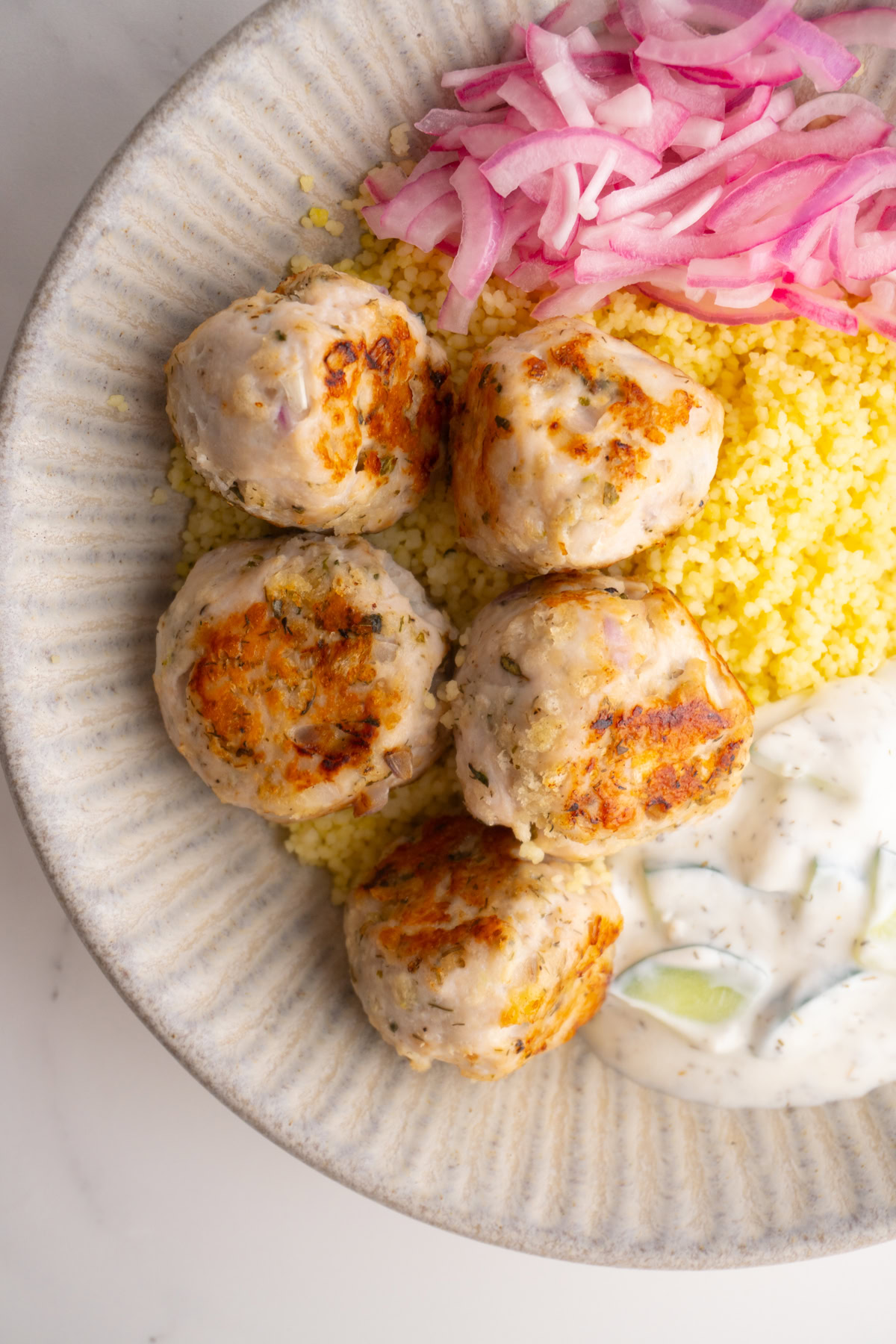 Close up of the Greek turkey meatballs in a Mediterranean meatball bowl.