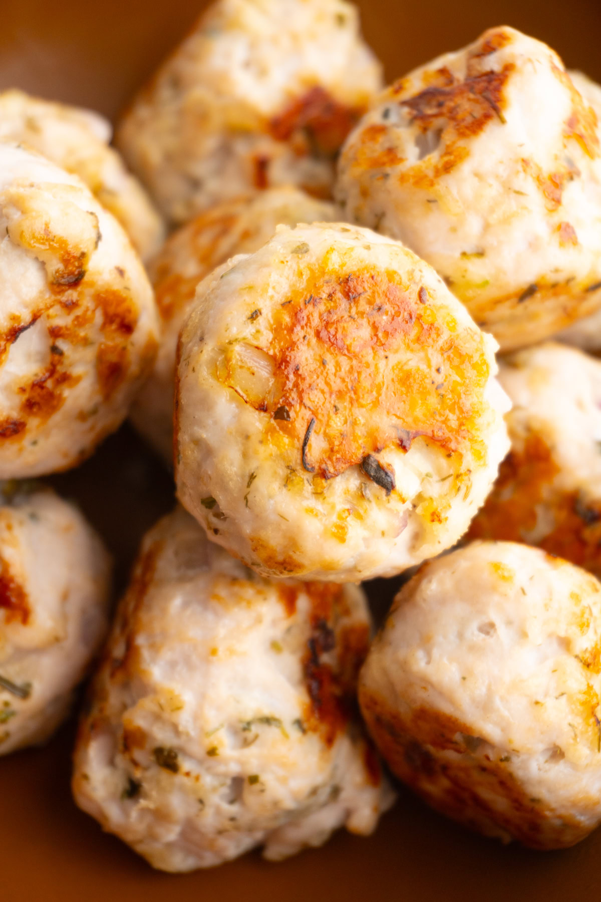 Close up shot of Greek turkey meatballs in a bowl.
