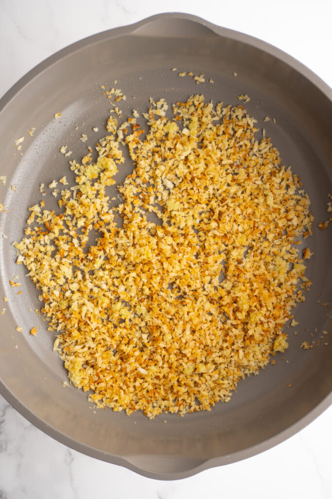 Toasted garlic breadcrumbs in a skillet.
