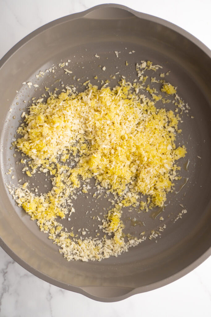Panko breadcrumbs added to the olive oil and garlic in a skillet.