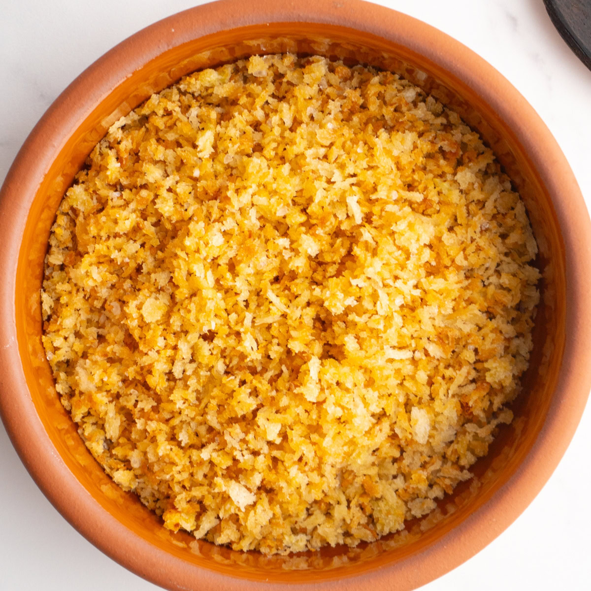 Overhead shot of garlic toasted breadcrumbs served in a bowl.