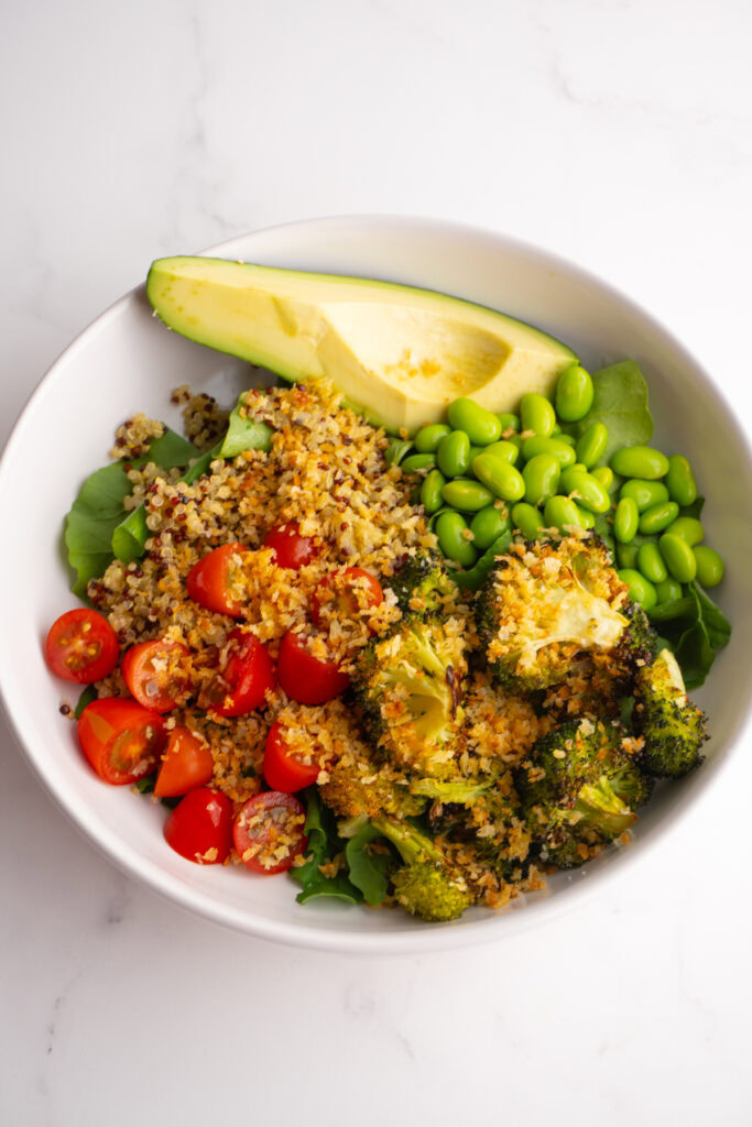 Green goddess grain bowl with crunchy breadcrumbs on top.