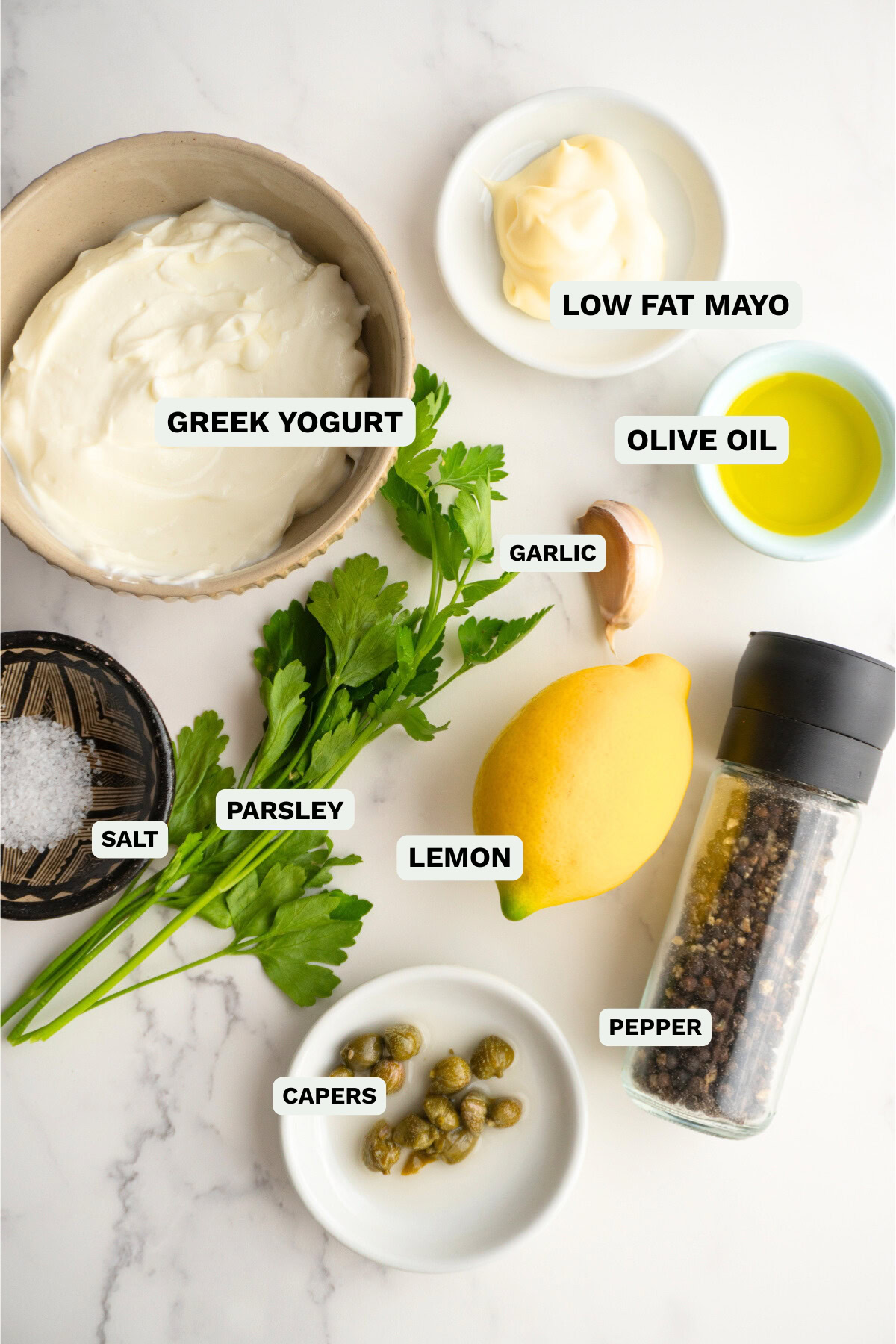 Ingredients needed to make green goddess dip on a counter.