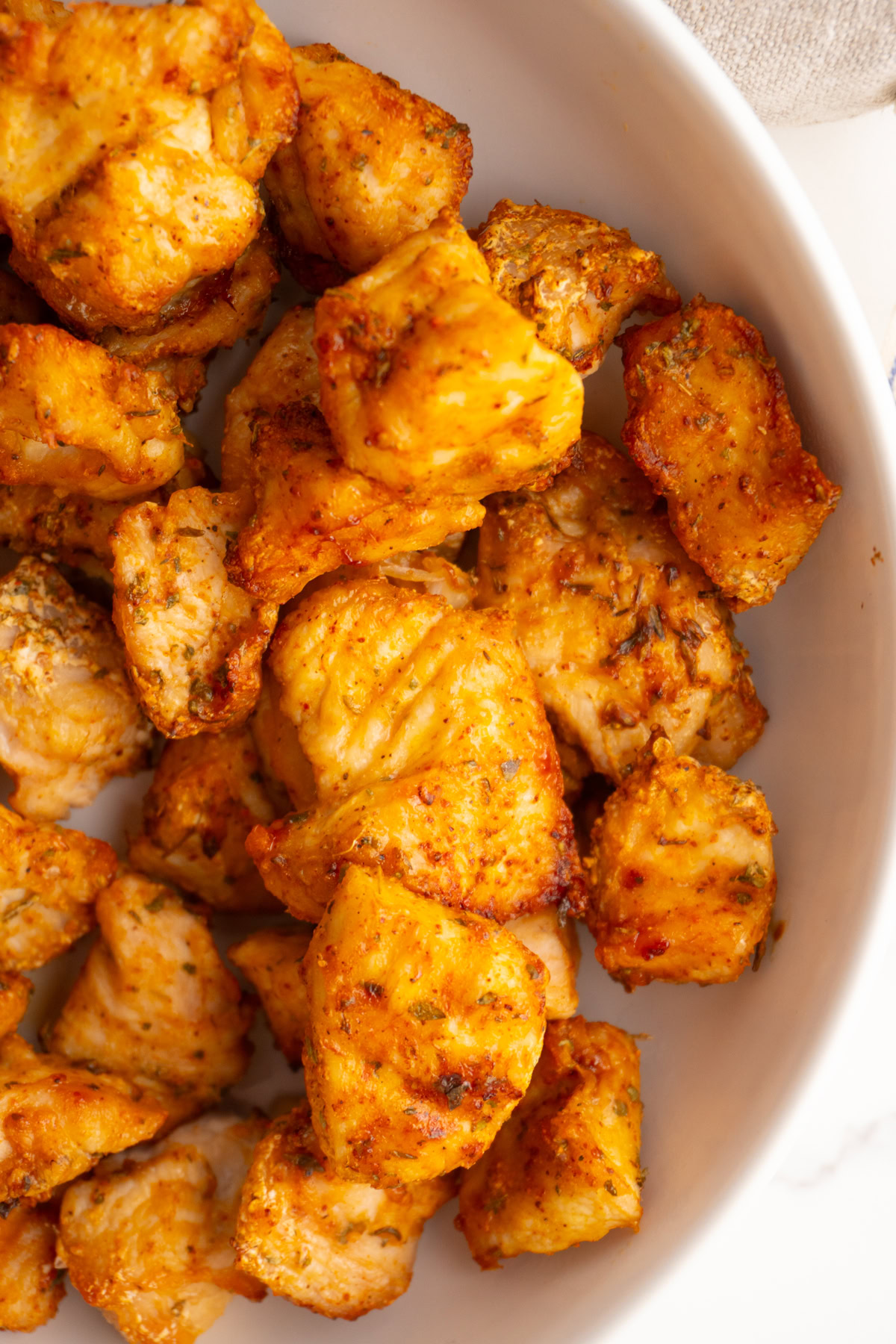 Close up of air fryer chicken bites served in a bowl.