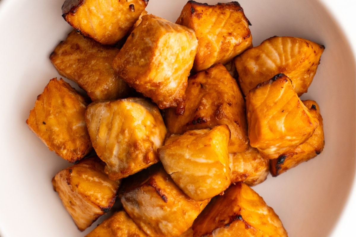 Close up of air fryer salmon bites in a bowl.