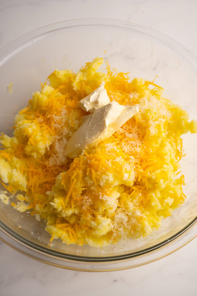 Cheddar cheese, parmesan cheese, garlic, and cream cheese added to the potatoes.