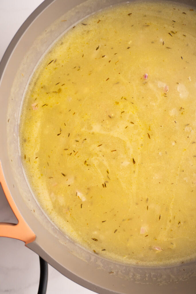 Finished chicken stock gravy in a skillet.