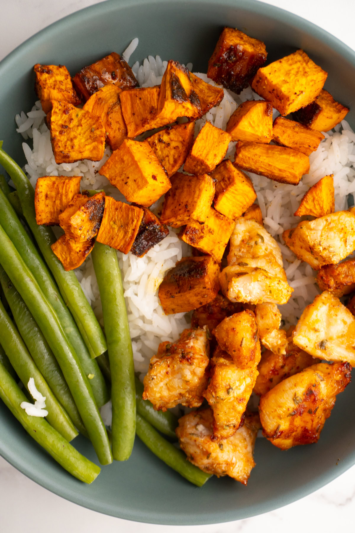 Air fried chicken bites served with rice and veggies.