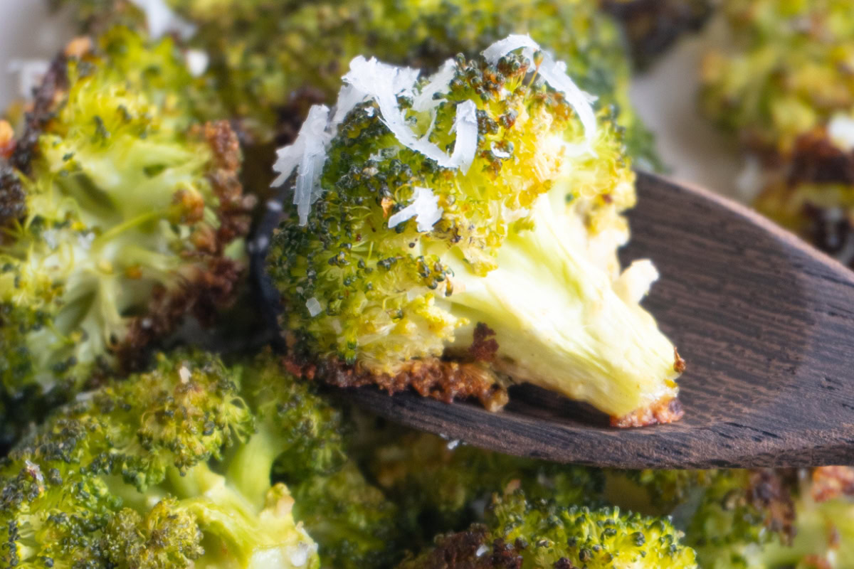 Close up of parmesan broccoli on a spoon.