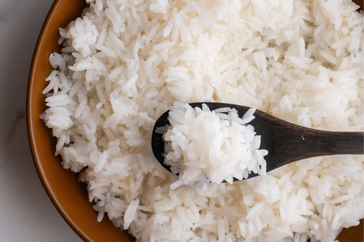 Close up of finished perfect rice with a small wooden spoon.