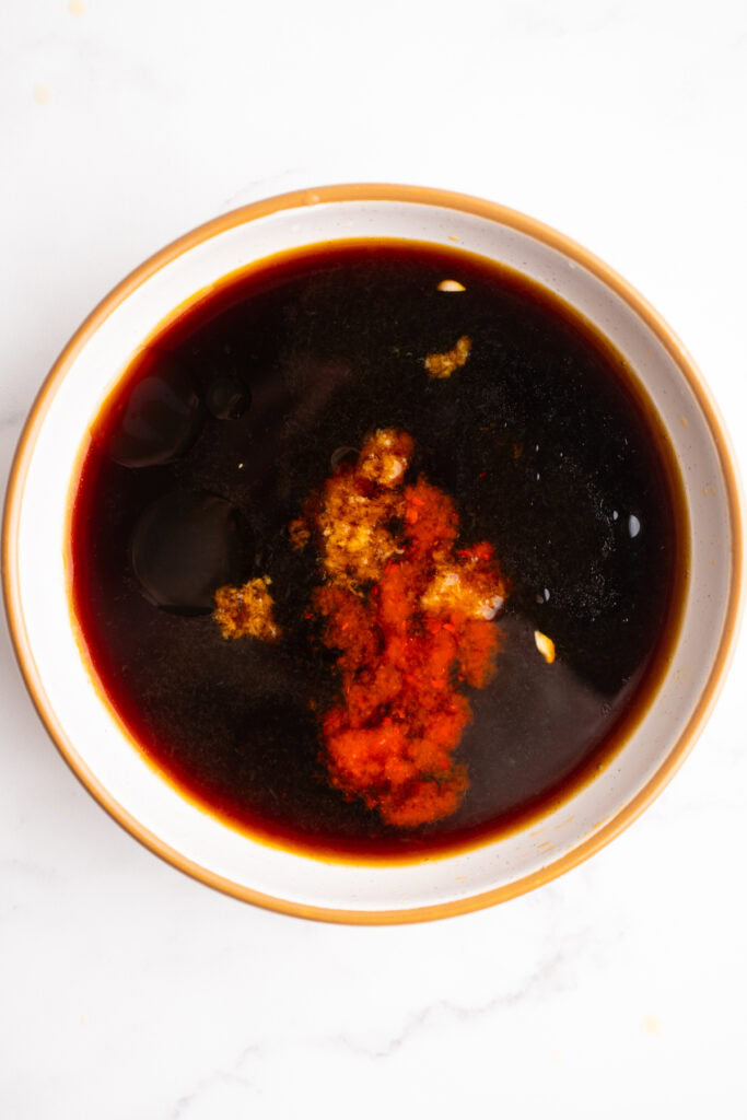 Ingredients for poke bowl sauce in a bowl before being whisked together.