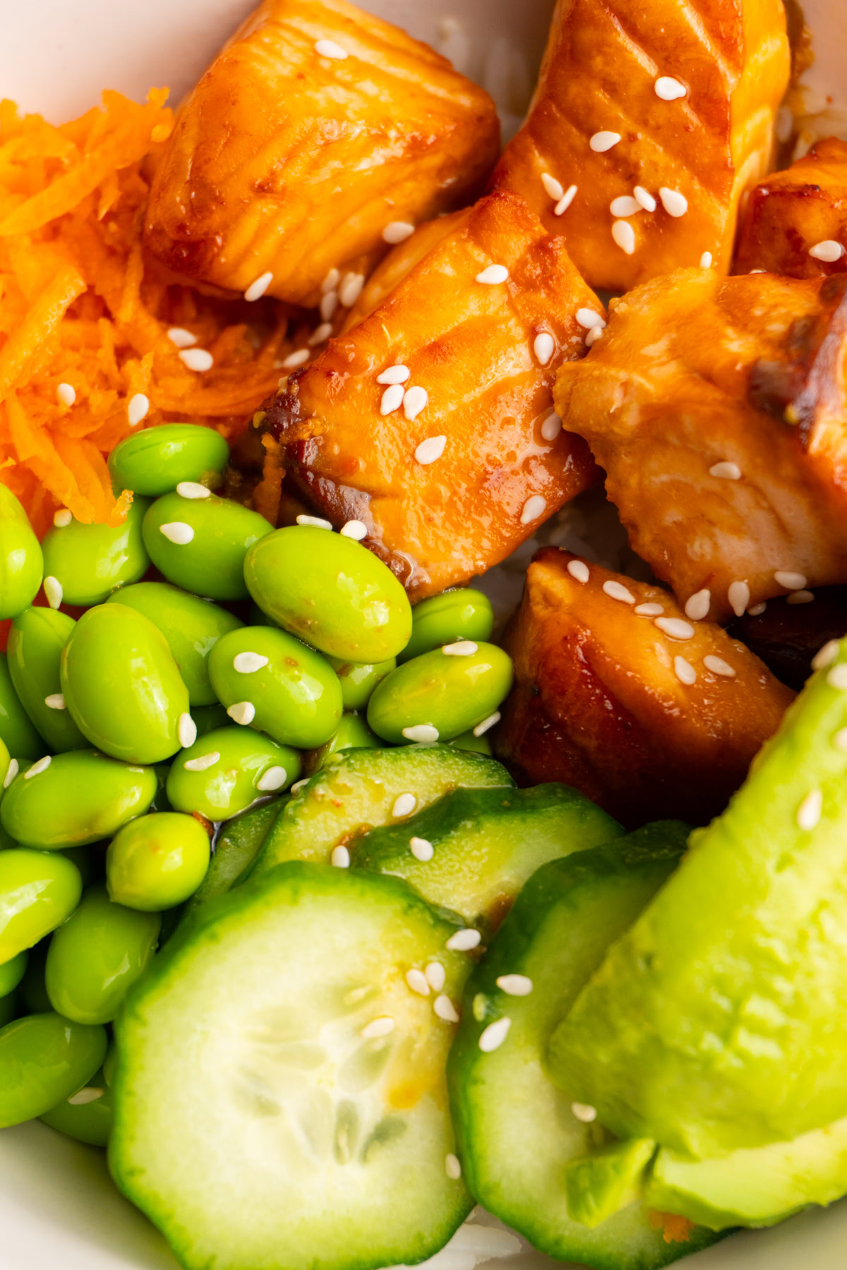 Close up of the salmon and toppings in a cooked salmon poke bowl.