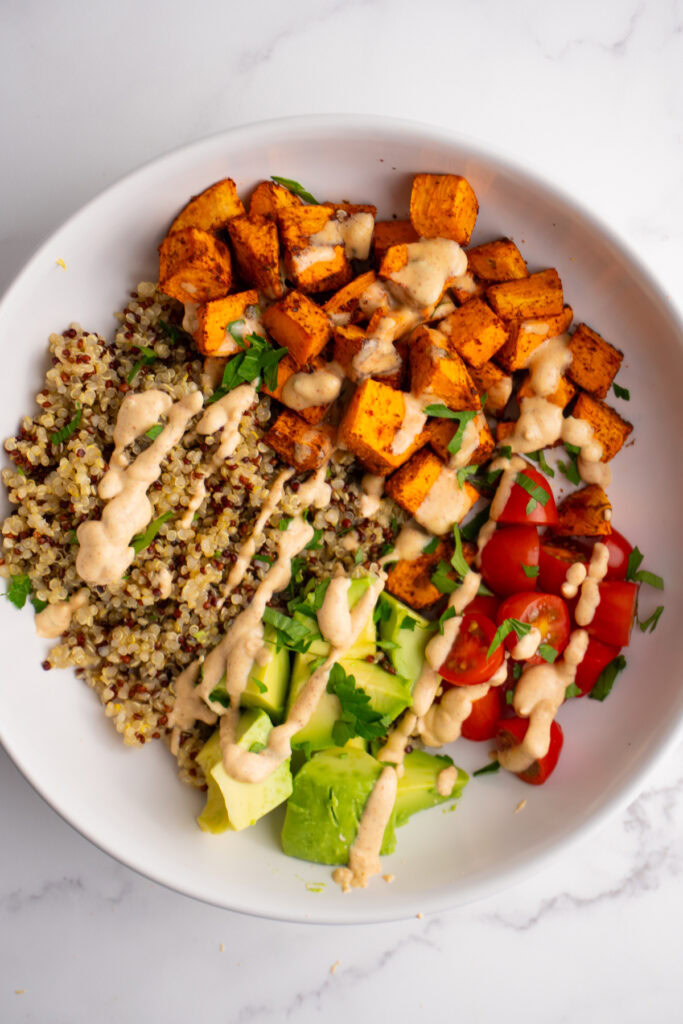 Sweet potato taco bowl with sweet potatoes, quinoa, veggies and taco sauce.